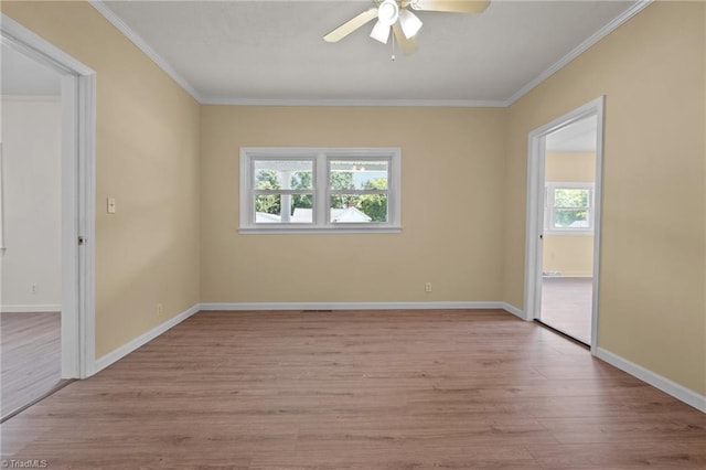 spare room featuring light wood-type flooring, ceiling fan, and crown molding