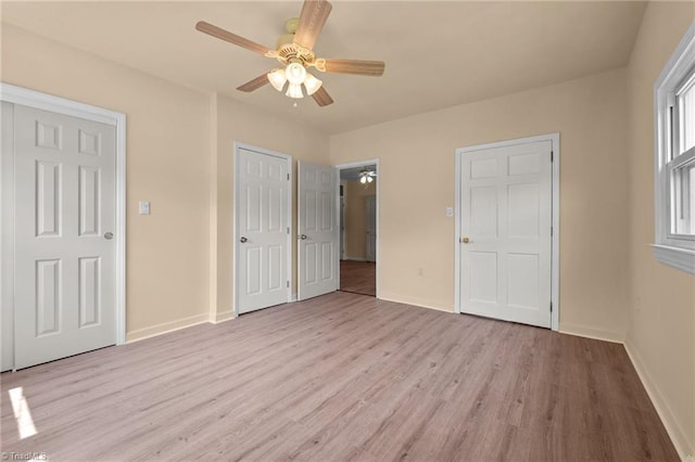 unfurnished bedroom with ceiling fan and light hardwood / wood-style floors