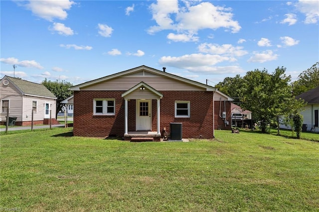 rear view of house featuring a yard and central air condition unit