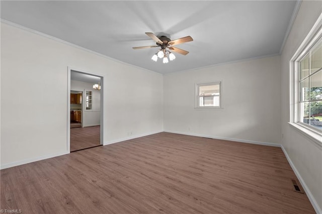 unfurnished bedroom featuring ceiling fan, ornamental molding, hardwood / wood-style floors, and multiple windows