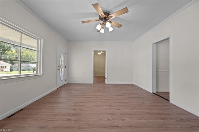 empty room with crown molding, ceiling fan, and light hardwood / wood-style floors