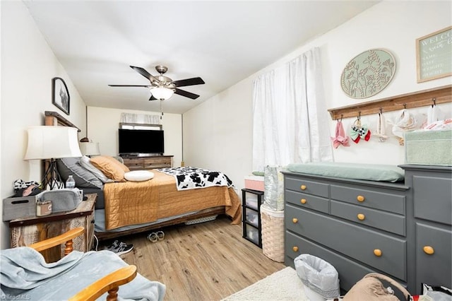 bedroom with a ceiling fan and light wood-style floors