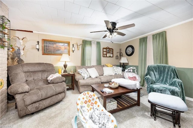 carpeted living room with a ceiling fan and crown molding