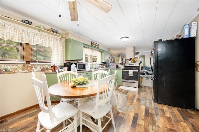 dining area featuring crown molding and hardwood / wood-style flooring