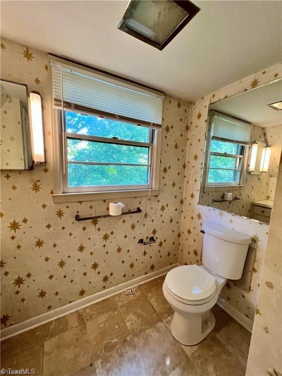 bathroom with vanity, toilet, tile patterned floors, and plenty of natural light