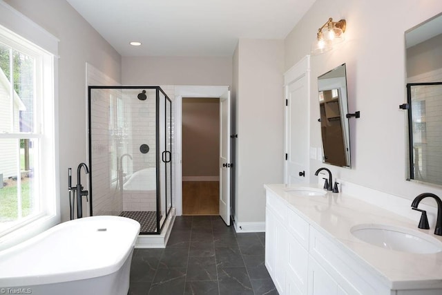 full bath with a stall shower, a soaking tub, double vanity, marble look tiles, and recessed lighting