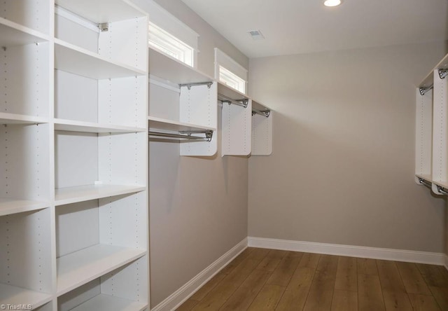 walk in closet featuring wood finished floors