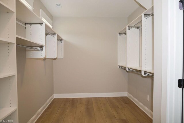 walk in closet featuring wood finished floors