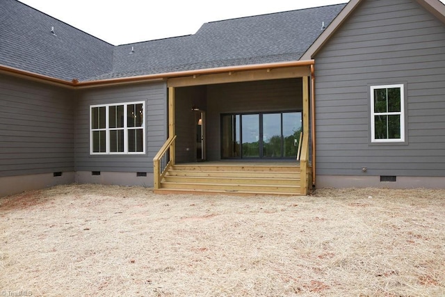 back of house with crawl space and a shingled roof