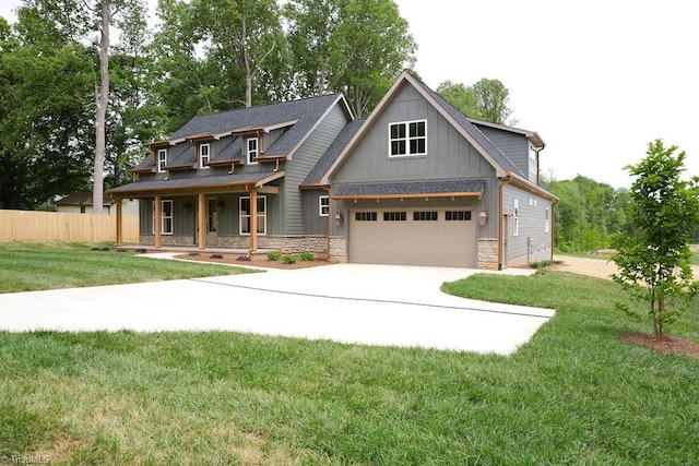 view of front of house featuring concrete driveway, covered porch, board and batten siding, stone siding, and a garage