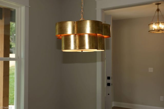 detailed view of a chandelier and baseboards