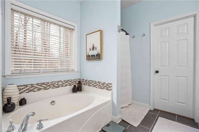 bathroom with a bathtub and tile patterned flooring