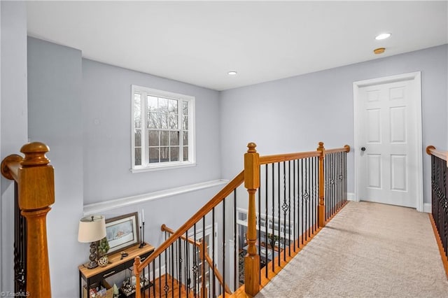 hall featuring carpet flooring