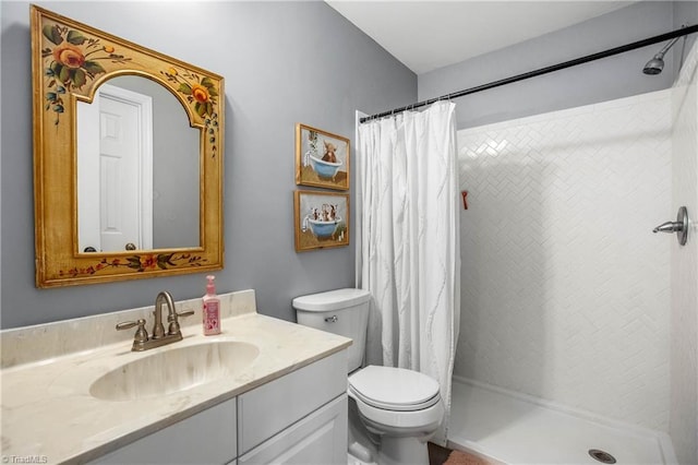 bathroom featuring vanity, toilet, and curtained shower