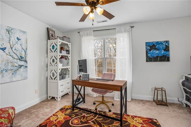 office space featuring light carpet and ceiling fan