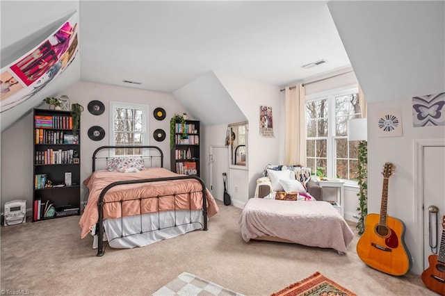 bedroom featuring multiple windows, vaulted ceiling, and carpet flooring