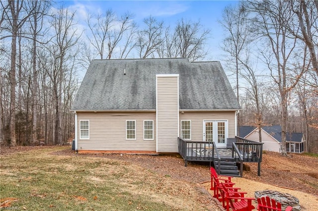 back of property with a lawn and a wooden deck