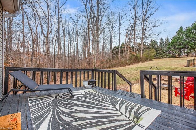 wooden deck with a lawn