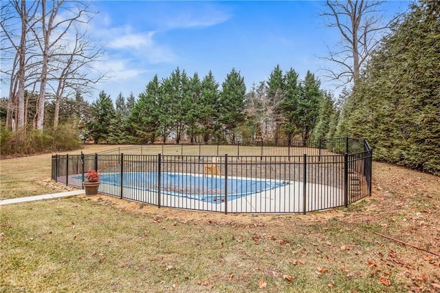 view of pool featuring a lawn