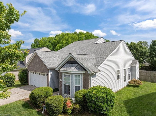 7150 Colorado Blvd, Thomasville, NC 27360 - view of front facade with a shingled roof, brick siding, an attached garage, and concrete driveway