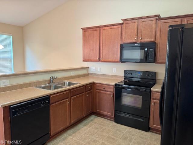 4373 Rex Ct, Winston-Salem, NC 27107 - kitchen featuring black appliances, a sink, a peninsula, light countertops, and lofted ceiling