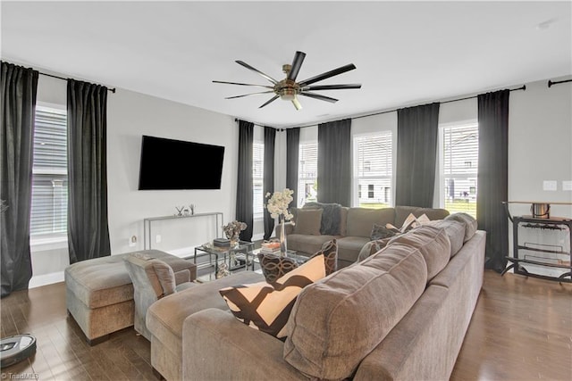 living room featuring ceiling fan and dark hardwood / wood-style flooring