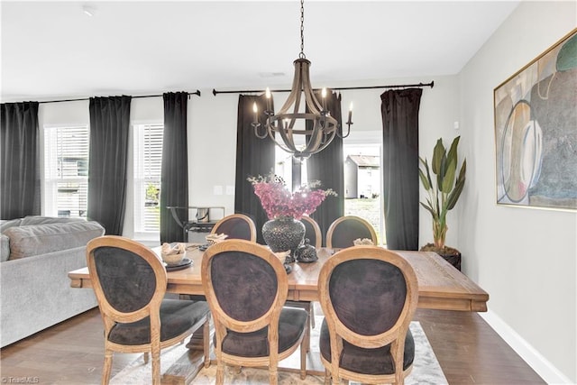 dining space featuring an inviting chandelier and dark hardwood / wood-style floors