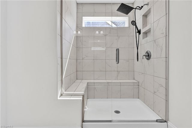 bathroom featuring a shower with door