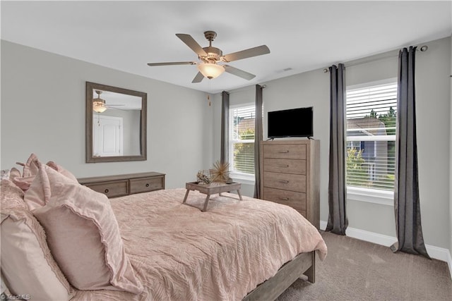 bedroom featuring ceiling fan and light carpet