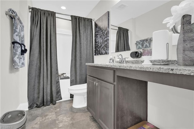 bathroom featuring toilet and vanity