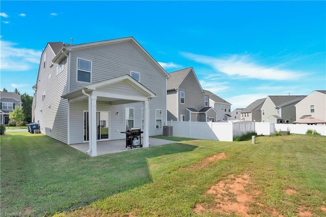 back of property featuring central air condition unit, a lawn, and a patio