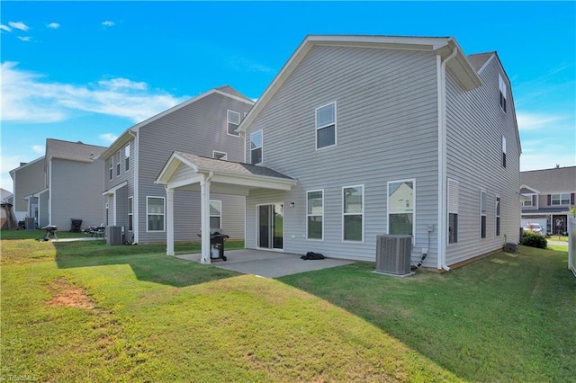 rear view of property featuring cooling unit, a yard, and a patio