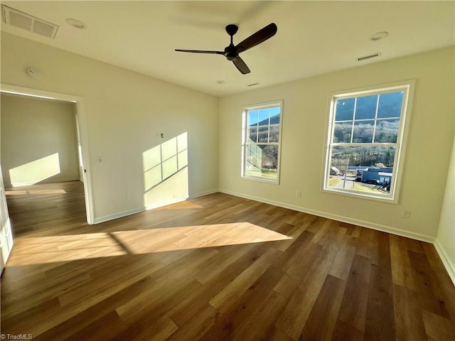 spare room featuring hardwood / wood-style flooring and ceiling fan