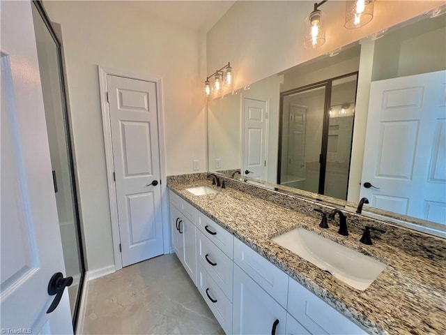 bathroom with vanity and a shower with door