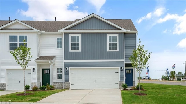 view of front of property with a garage and a front lawn