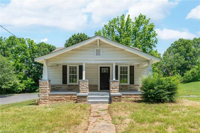 127 Oak Summit Rd, Winston-Salem, NC 27105 - view of front of home with covered porch, stone siding, and a front lawn