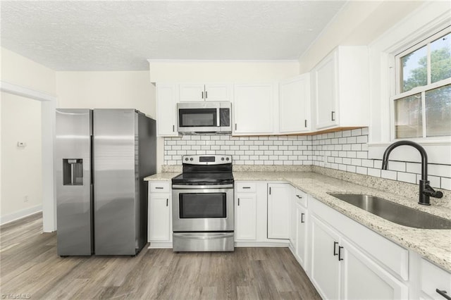 127 Oak Summit Rd, Winston-Salem, NC 27105 - kitchen featuring stainless steel appliances, dark wood-style floors, a textured ceiling, decorative backsplash, and white cabinetry