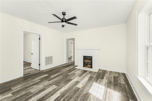 127 Oak Summit Rd, Winston-Salem, NC 27105 - unfurnished living room with wood finished floors, ceiling fan, and a fireplace with flush hearth