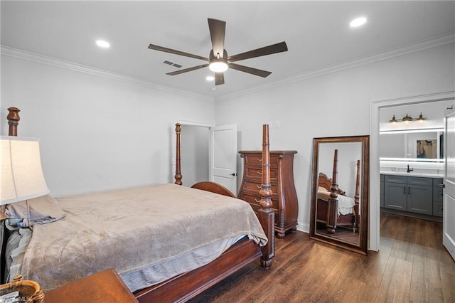 bedroom with dark wood-type flooring, ceiling fan, crown molding, and connected bathroom