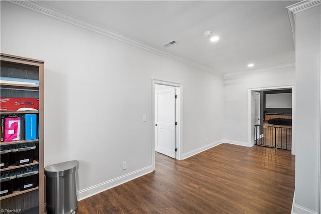 spare room with dark hardwood / wood-style floors and crown molding