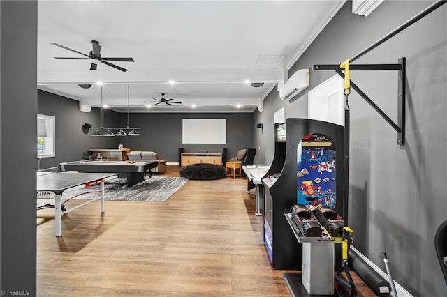 rec room featuring ornamental molding, wood-type flooring, an AC wall unit, and ceiling fan