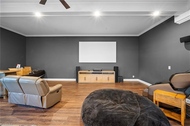 home theater room featuring ornamental molding, light hardwood / wood-style floors, and ceiling fan