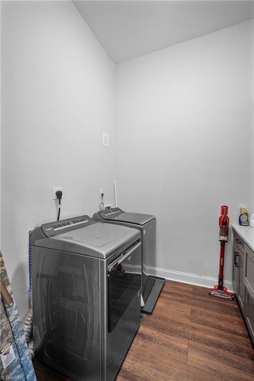 laundry room featuring washer and clothes dryer and dark hardwood / wood-style floors