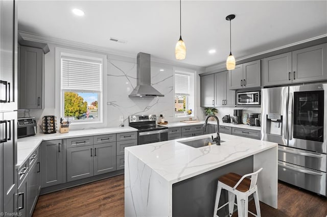 kitchen featuring a wealth of natural light, appliances with stainless steel finishes, sink, and wall chimney range hood