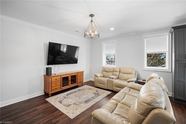 living room with a wealth of natural light, a chandelier, and dark hardwood / wood-style flooring