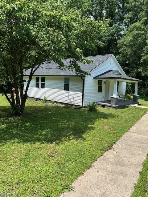 545 S Fieldcrest Rd, Eden, NC 27288 - view of front of house featuring a porch, a front lawn, and a shingled roof