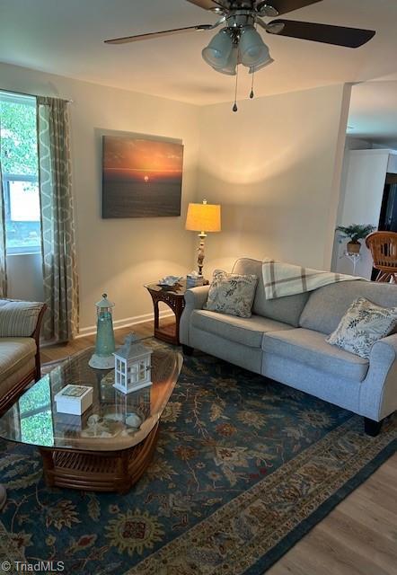 545 S Fieldcrest Rd, Eden, NC 27288 - living room featuring a ceiling fan, wood finished floors, and baseboards