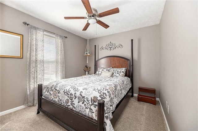 carpeted bedroom with a ceiling fan and baseboards