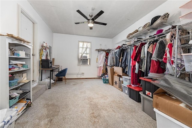 spacious closet featuring cooling unit, carpet flooring, and ceiling fan