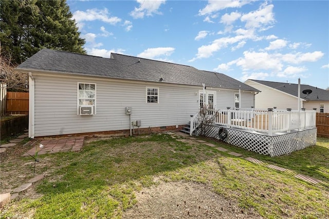 rear view of house featuring a shingled roof, a lawn, crawl space, fence, and a wooden deck